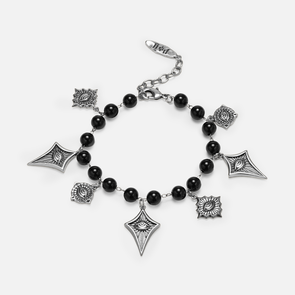 A gothic-style charm bracelet featuring black beads and silver-toned charms, including eye motifs, kites, and sunbursts, displayed on a light gray background.