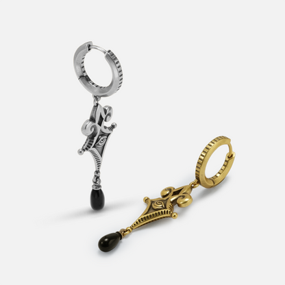 Antiqued silver- and gold-tone Watcher’s Tear Earrings displayed from angled views to show the hoops, frames, and black drops.