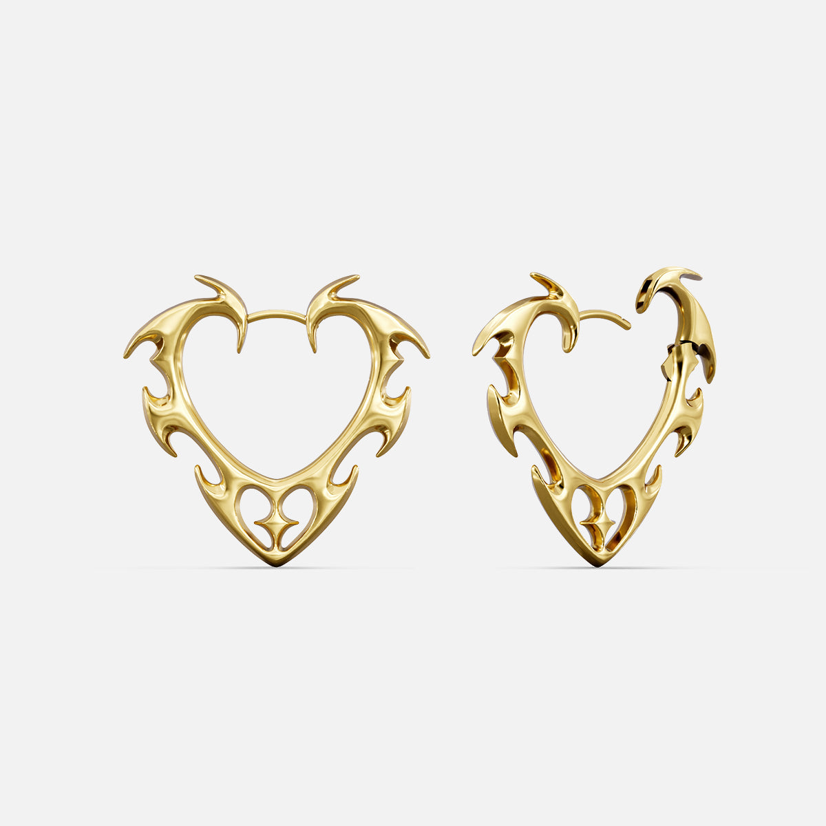 Pair of gold Wild Heart earrings with open thorn-edged heart shapes
