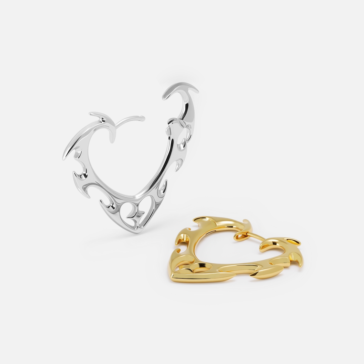 Silver and gold Wild Heart earrings shown open and lying flat