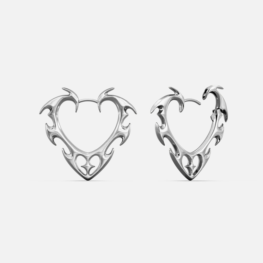 Pair of silver-tone wild heart earrings with thorn-like edges and cutout heart details, front and side views