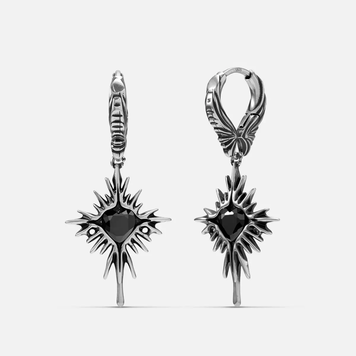 Winged Heartburst Earrings in 925 sterling silver, pair shown front and back on white, with black heart centers, spiked rays,
