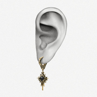 Gold-tone Winged Heartburst hoop earring positioned on an illustrated earlobe to show the full drop