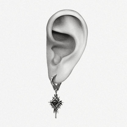 Silver-tone Winged Heartburst hoop earring positioned on an illustrated earlobe with a black heart center
