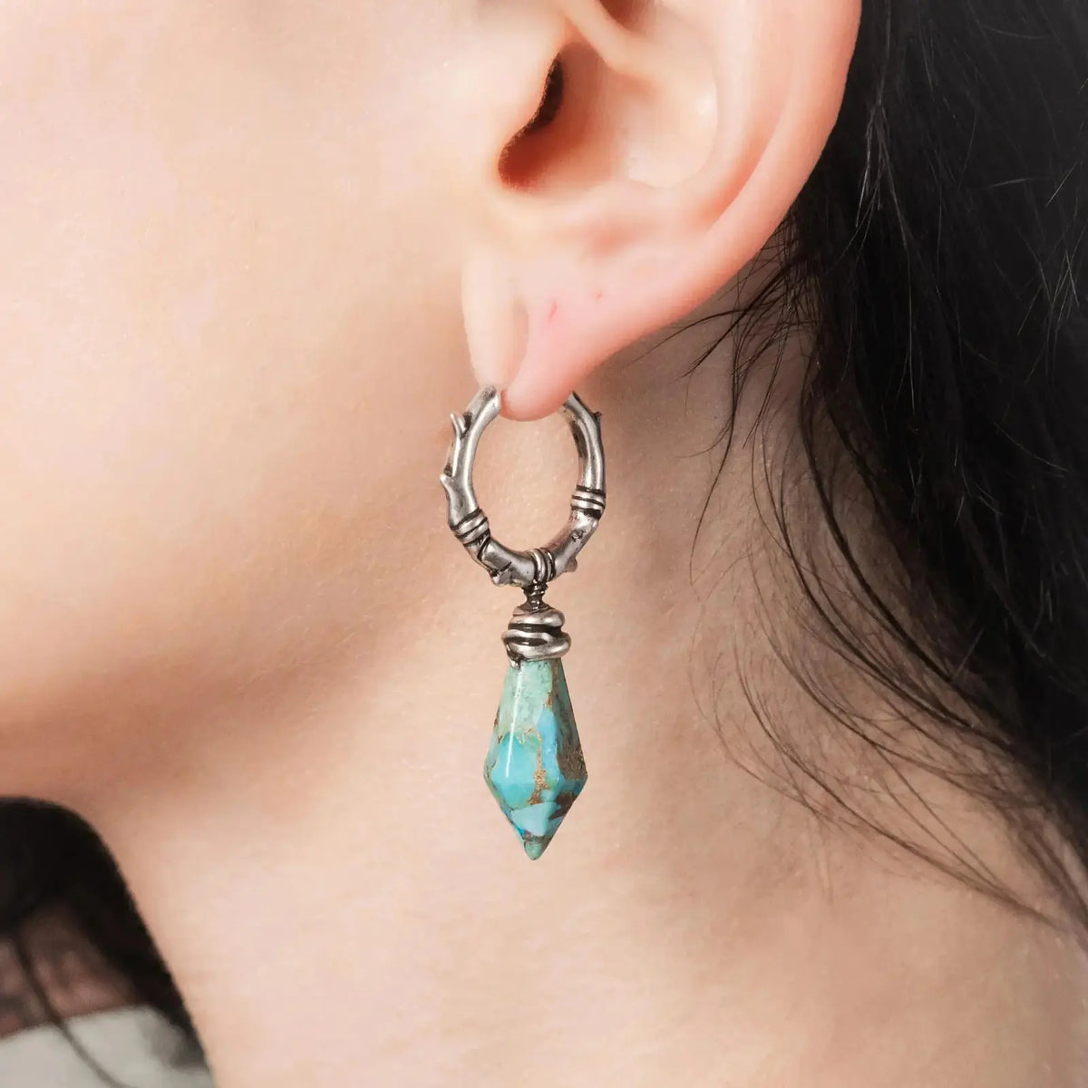 Wrapped Relic Earrings in 925 sterling silver, worn in a close ear view, showing the faceted turquoise relic-shaped drop and 