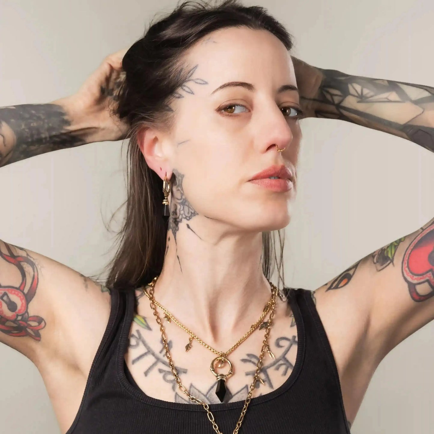 Model wearing gold Wrapped Relic Earrings with obsidian stone drops and witchwood inspired styling