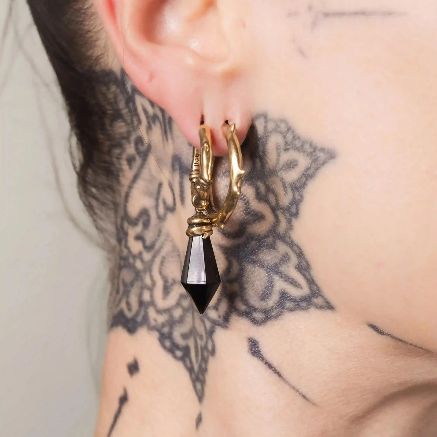 Gold Wrapped Relic Earrings styled on model with black dagger drops and gothic jewelry mood