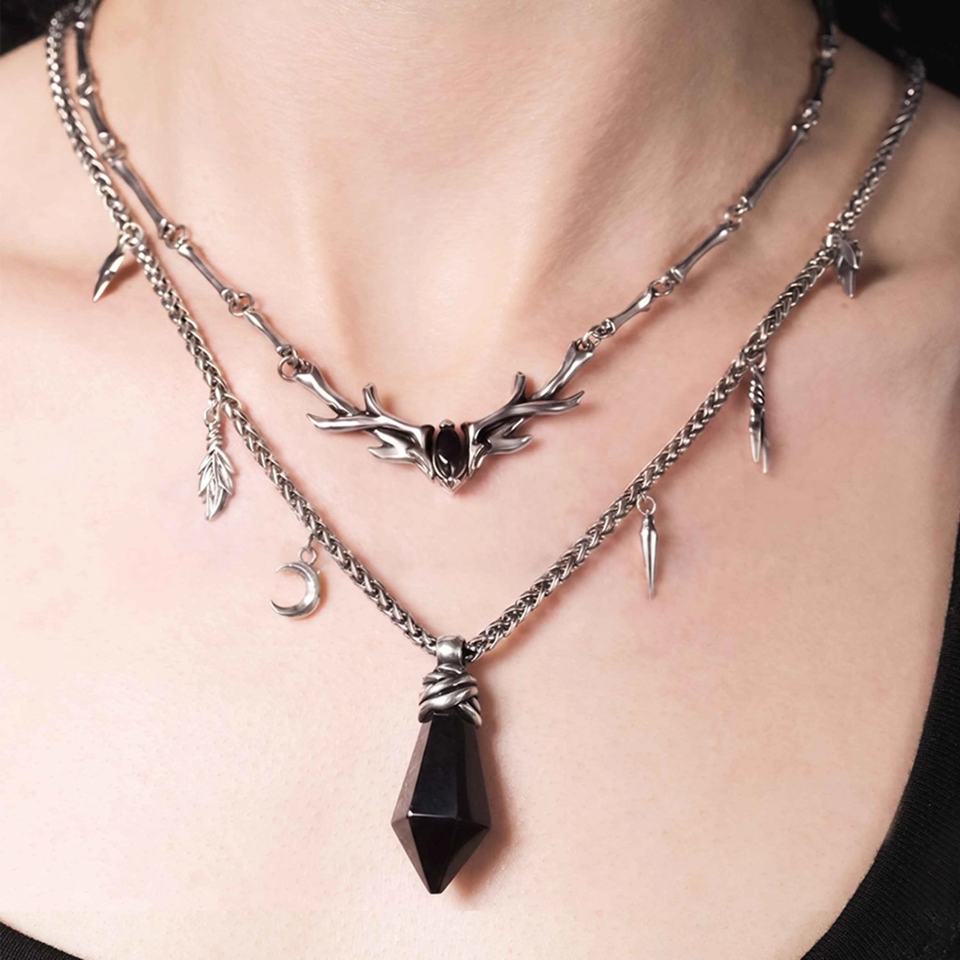 Black obsidian Wrapped Relic Necklace worn with layered gothic jewelry, showing its dark forest relic mood and ritual-inspired details.