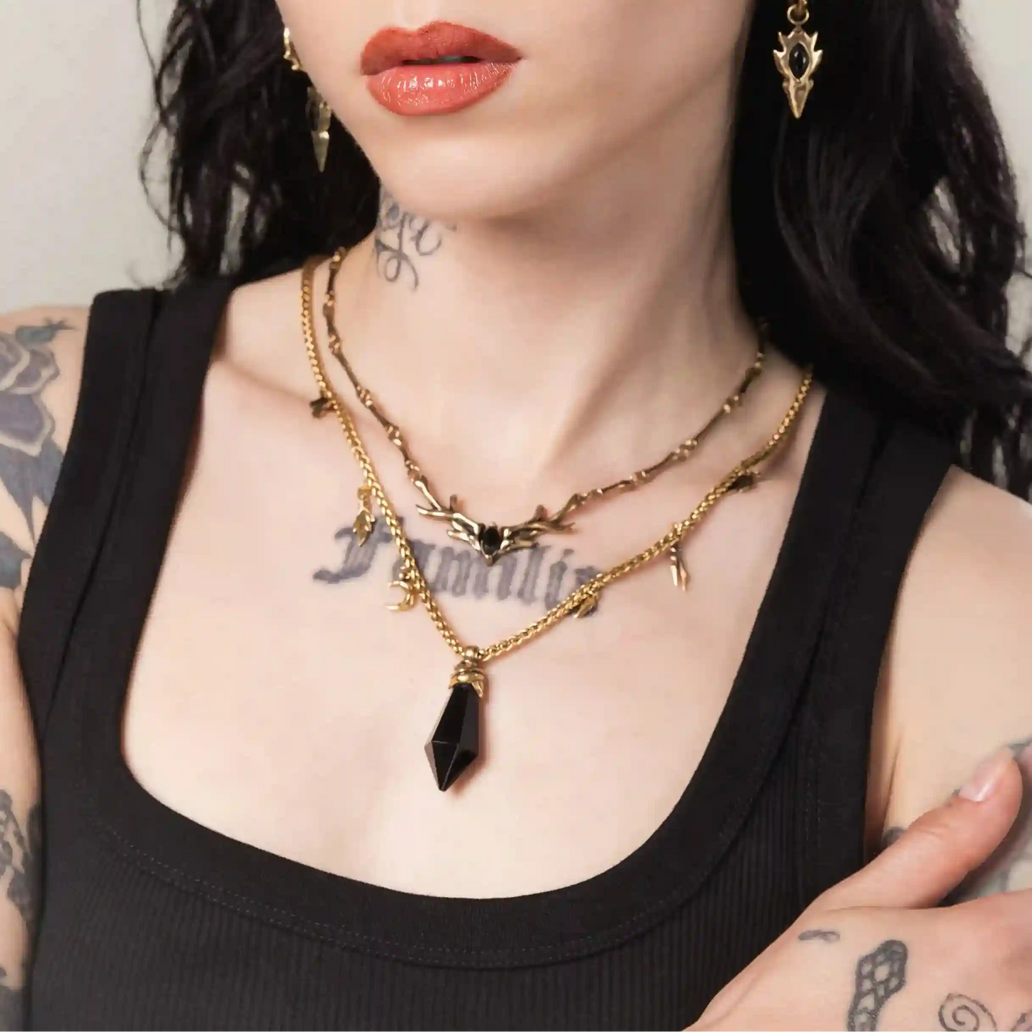 Gold Wrapped Relic Necklace styled on model with black stone pendant and gothic jewelry details