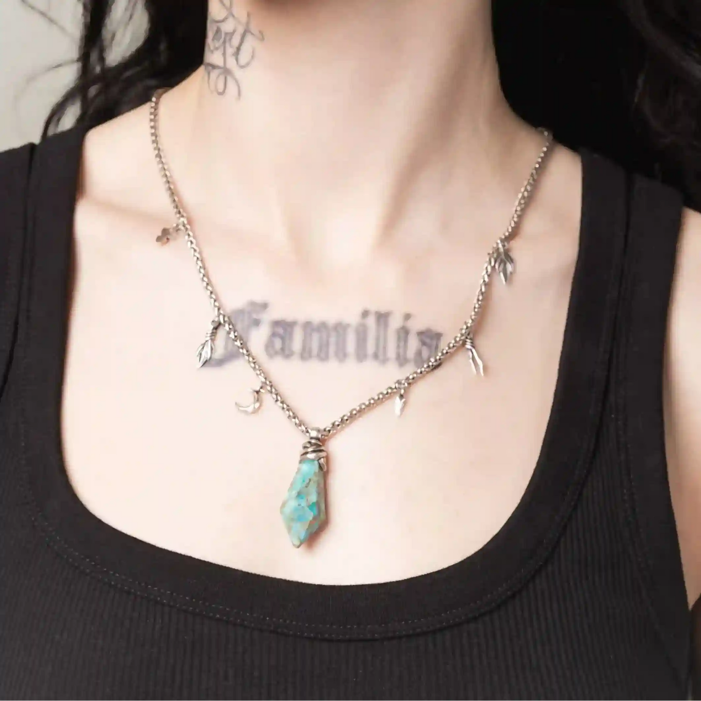 Silver Wrapped Relic Necklace styled on model with raw turquoise pendant and gothic charm chain