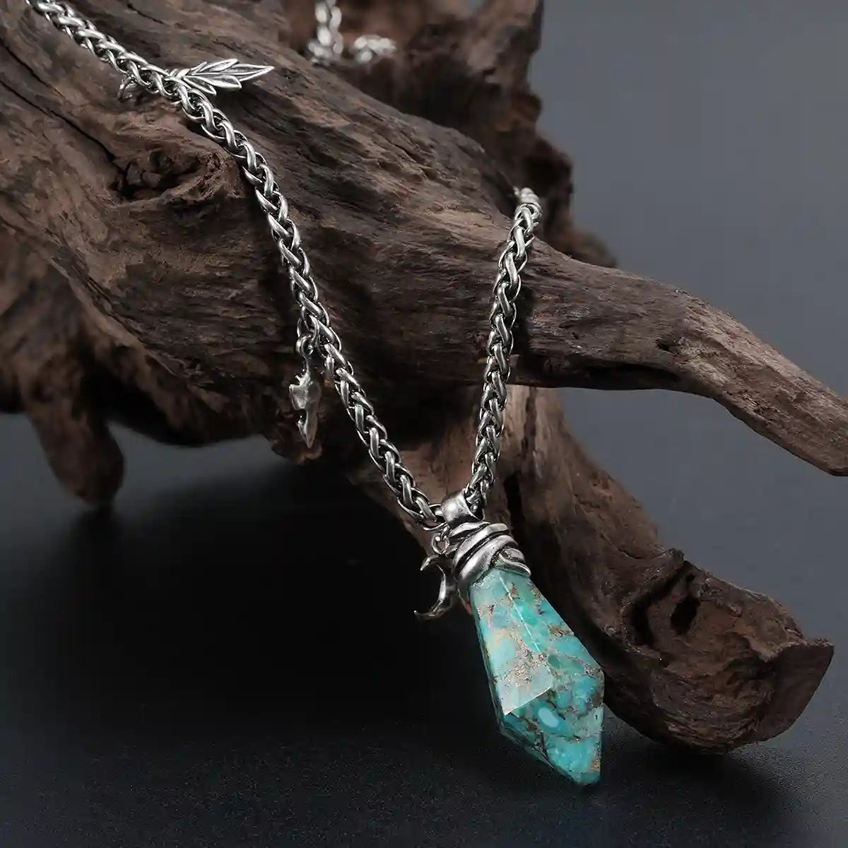 Silver Wrapped Relic Necklace with turquoise stone pendant displayed on weathered wood