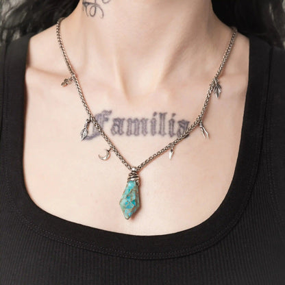 Model wearing the silver Wrapped Relic Necklace with turquoise stone pendant and wire wrap detail